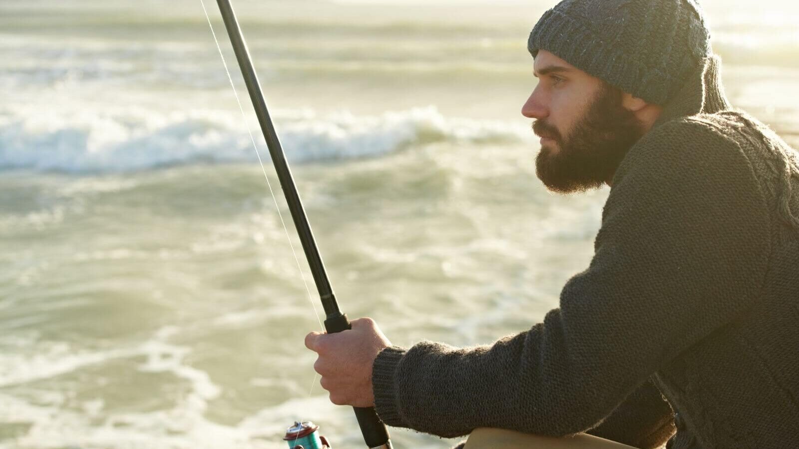 A man with a beard is fishing at Silverwood Lake.